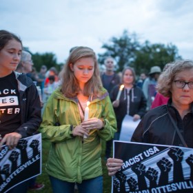 Women holding candles at vigil to show solidarity after Charlottesville incident