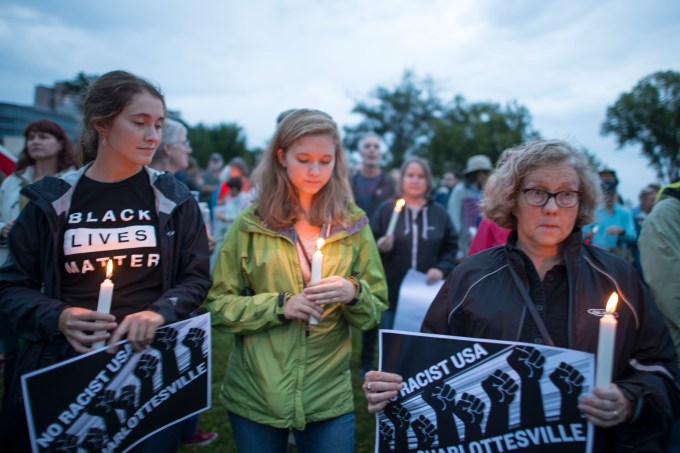 Women holding candles at vigil to show solidarity after Charlottesville incident